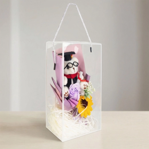 Künstliche Dekoration mit Sonnenblume und Teddybär in Geschenkbox
