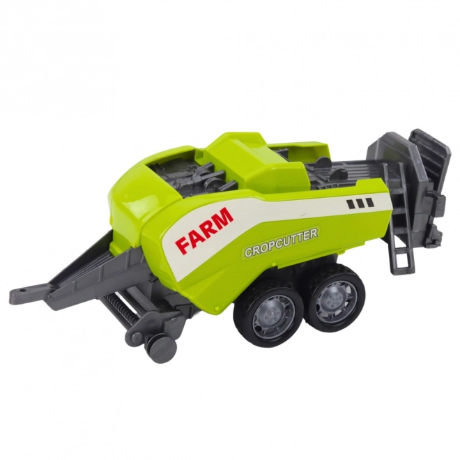 Roter Traktor mit Frontlader und Ballenpresse