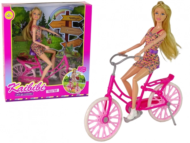 Puppe mit Fahrrad in Pink