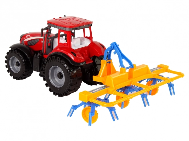 Roter Traktor mit Schwader Friktionsantrieb