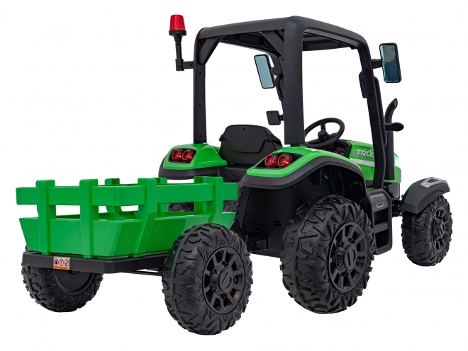 Kindertraktor mit grünem Anhänger