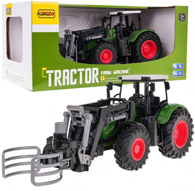 Grüner Traktor mit Greifer