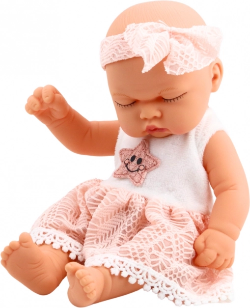Schlafende Babypuppe in rosa Kleid mit Spitze und Sternstirnband