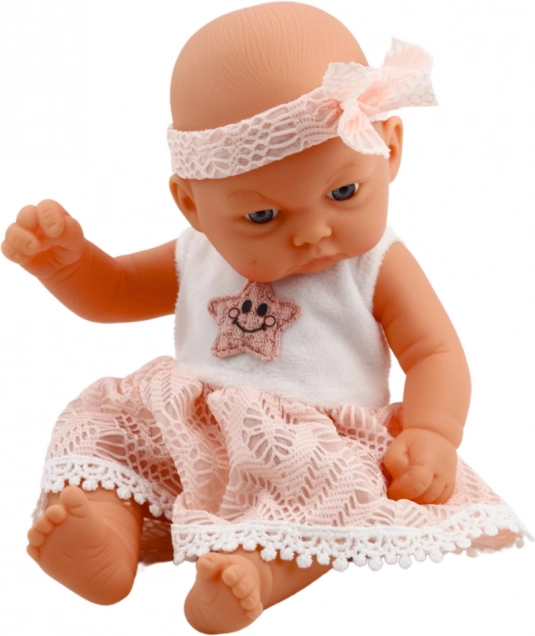 Babypuppe im rosa Kleid mit Haarband