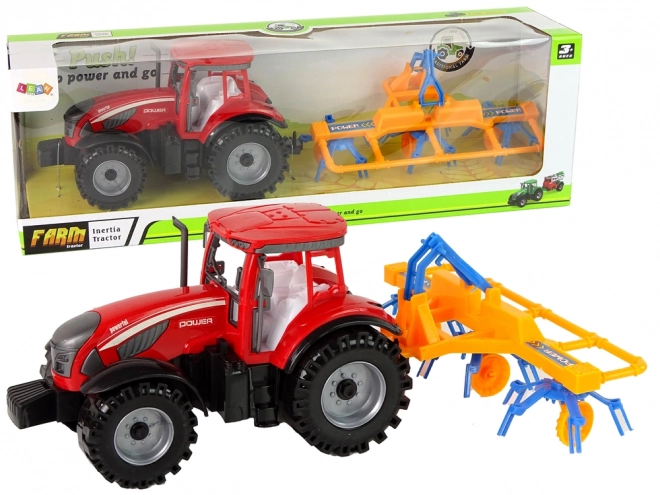 Roter Traktor mit Schwader Friktionsantrieb