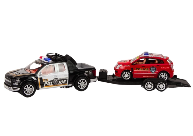 Zwei Polizeifahrzeuge mit Abschleppanhänger