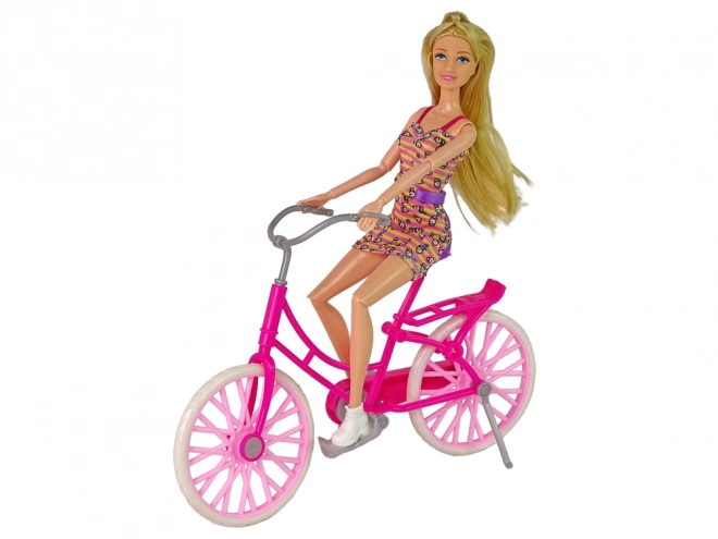 Puppe mit Fahrrad in Pink